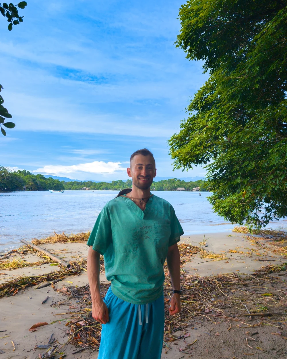 Nathan Marko Markarian in scrubs on a riverbank in Bocas del Toro, Panama, during a Floating Doctors mobile clinic
